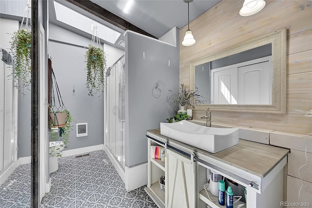 bathroom featuring vanity, wooden walls, vaulted ceiling, and curtained shower