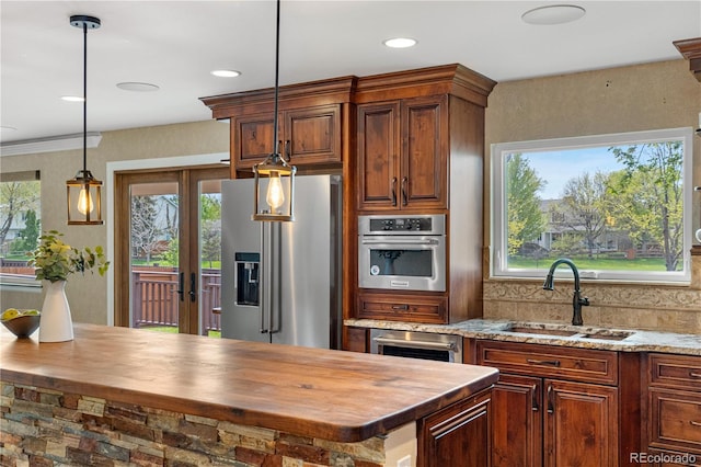 3418 Elk Ct, Broomfield, CO 80020 - kitchen featuring stainless steel appliances, butcher block countertops, a sink, plenty of natural light, and recessed lighting