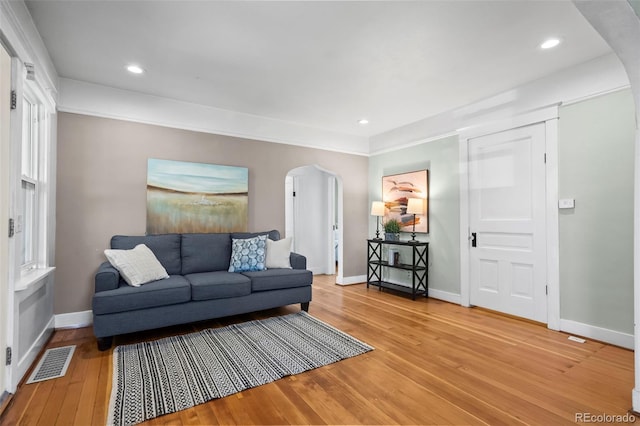 5008 Sherman St, Denver, CO 80216 - living area with arched walkways, light wood finished floors, and recessed lighting