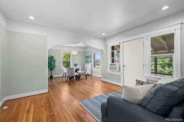 5008 Sherman St, Denver, CO 80216 - living area featuring plenty of natural light, hardwood / wood-style floors, cooling unit, arched walkways, and recessed lighting