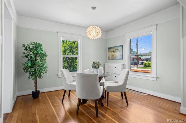 5008 Sherman St, Denver, CO 80216 - dining room with a chandelier, hardwood / wood-style flooring, and plenty of natural light