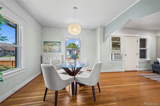 5008 Sherman St, Denver, CO 80216 - dining area with a chandelier, light wood-style flooring, and cooling unit