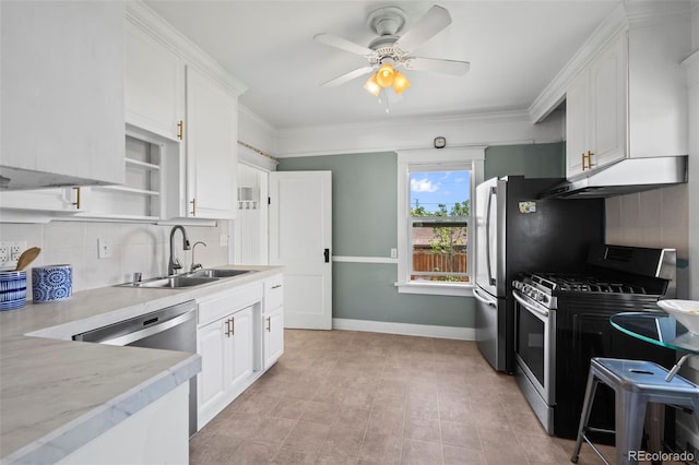 5008 Sherman St, Denver, CO 80216 - kitchen with stainless steel range with gas stovetop, under cabinet range hood, light countertops, tasteful backsplash, and white cabinetry