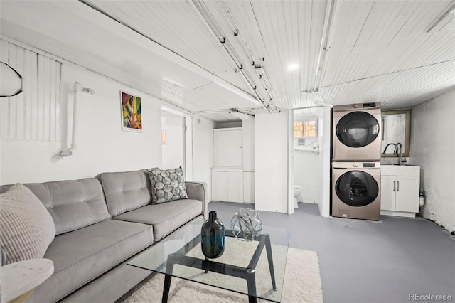 5008 Sherman St, Denver, CO 80216 - living area featuring estacked washer and dryer and concrete flooring