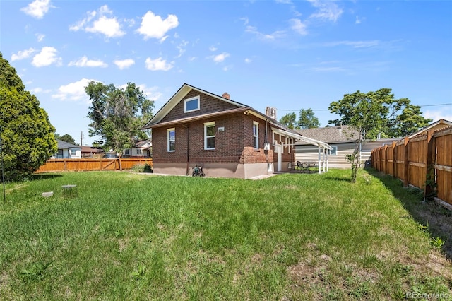 5008 Sherman St, Denver, CO 80216 - back of property with a fenced backyard, brick siding, and a chimney