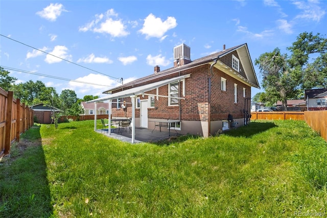5008 Sherman St, Denver, CO 80216 - rear view of house with brick siding, a patio, and a fenced backyard