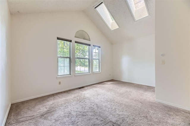 4130 E 94th Ave Unit B, Thornton, CO 80229 - carpeted spare room with a skylight and high vaulted ceiling