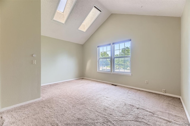 4130 E 94th Ave Unit B, Thornton, CO 80229 - unfurnished room featuring a skylight, carpet flooring, high vaulted ceiling, and a textured ceiling