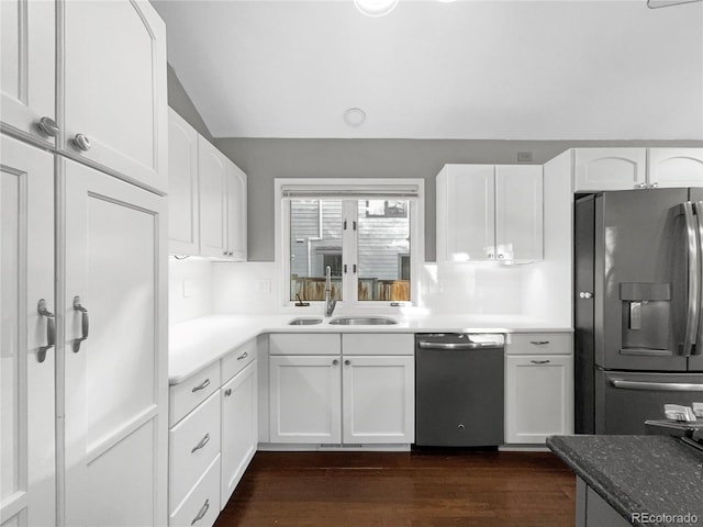 kitchen with sink, appliances with stainless steel finishes, white cabinets, dark hardwood / wood-style flooring, and vaulted ceiling