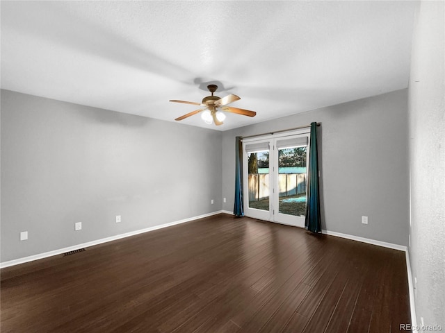 spare room featuring dark hardwood / wood-style flooring and ceiling fan