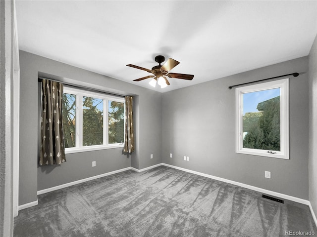 carpeted empty room featuring ceiling fan