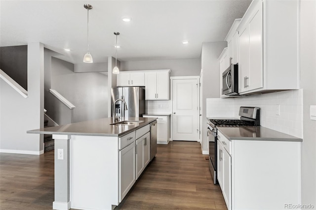 2248 Rosette Ln, Castle Rock, CO 80104 - kitchen with stainless steel appliances, dark wood-style flooring, tasteful backsplash, recessed lighting, and a kitchen island with sink