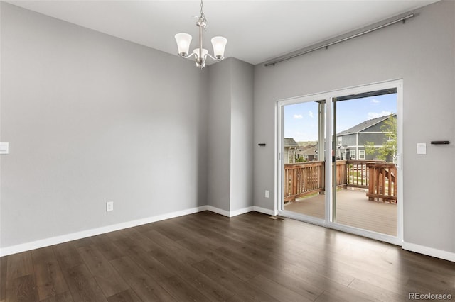 2248 Rosette Ln, Castle Rock, CO 80104 - empty room featuring dark wood-style flooring and a chandelier