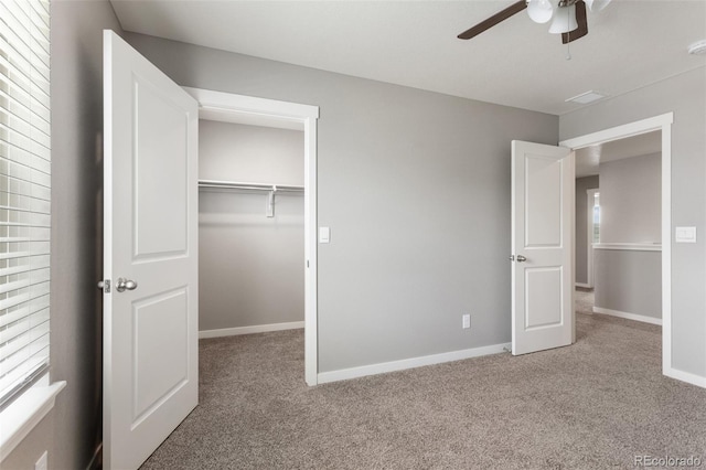 2248 Rosette Ln, Castle Rock, CO 80104 - unfurnished bedroom with carpet floors, a closet, ceiling fan, and a walk in closet