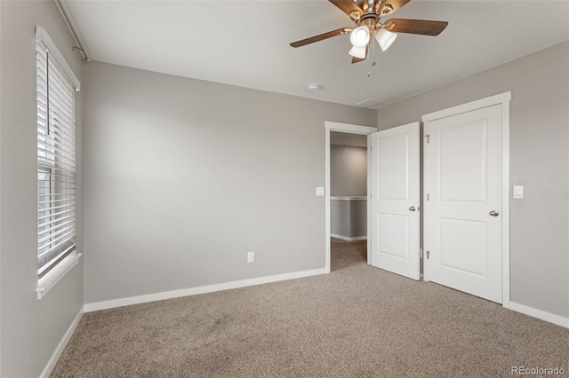 2248 Rosette Ln, Castle Rock, CO 80104 - unfurnished bedroom with carpet flooring, multiple windows, and a ceiling fan