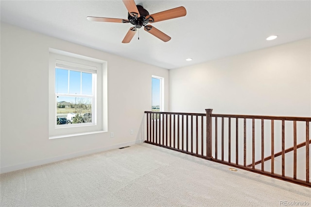 empty room with recessed lighting, baseboards, carpet, and a ceiling fan