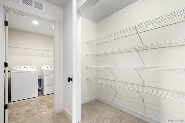 pantry featuring washer and clothes dryer