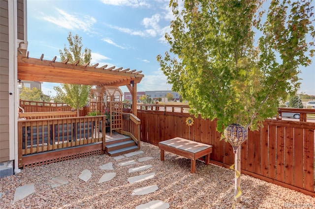 view of yard featuring a wooden deck, a pergola, and fence