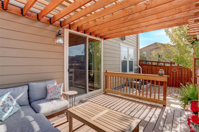 wooden terrace with outdoor lounge area and a pergola