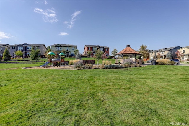 view of yard with playground community, a gazebo, and a residential view