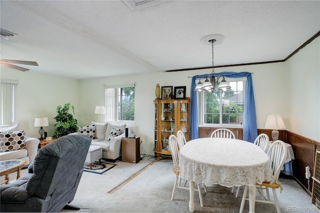 9642 Meade Ct, Westminster, CO 80031 - carpeted dining space with a textured ceiling, a ceiling fan, and a chandelier