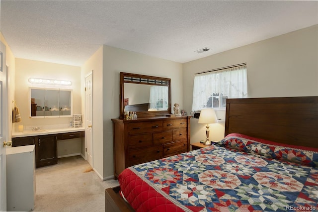 9642 Meade Ct, Westminster, CO 80031 - bedroom featuring light colored carpet, ensuite bathroom, and a textured ceiling