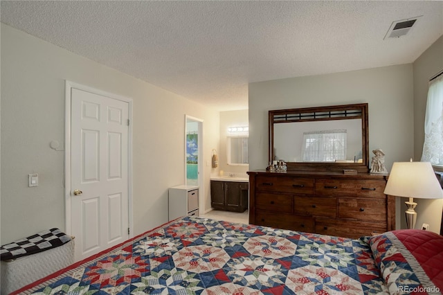 9642 Meade Ct, Westminster, CO 80031 - bedroom with a textured ceiling, ensuite bathroom, and light carpet