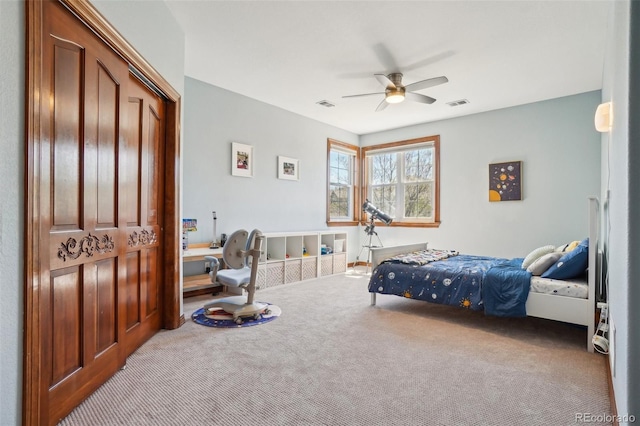 carpeted bedroom featuring a ceiling fan and a closet