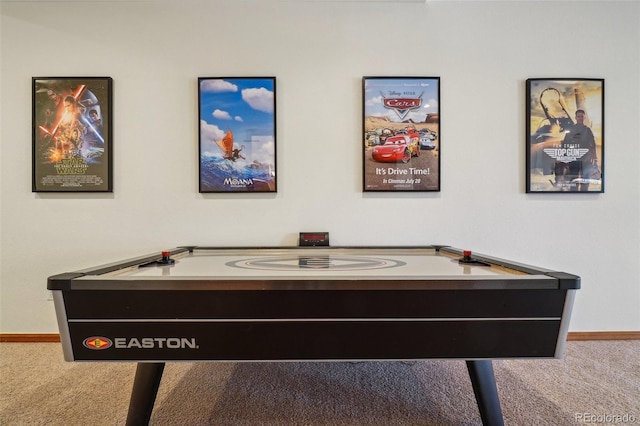 recreation room with carpet and baseboards