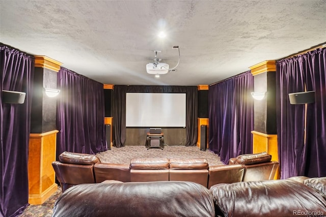 carpeted home theater with a textured ceiling