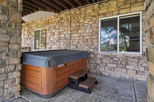 exterior view of a jacuzzi and stone siding