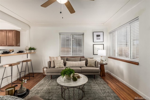 living room with dark hardwood / wood-style floors and ceiling fan