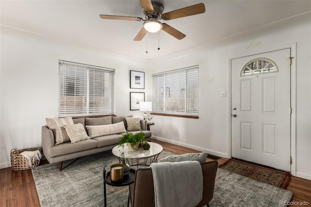 living room featuring ceiling fan and dark wood-type flooring