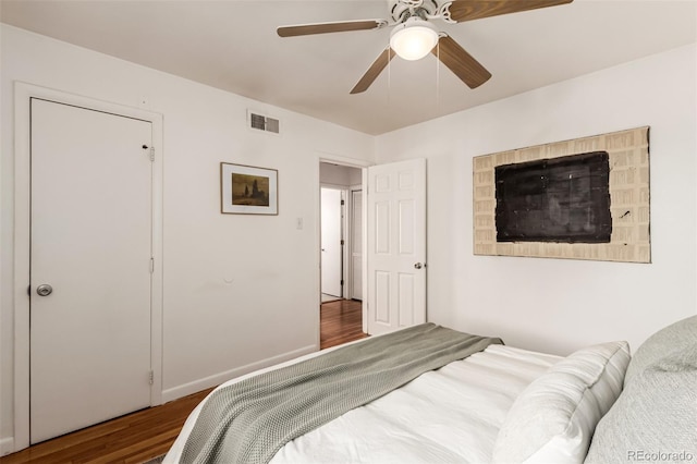 bedroom featuring ceiling fan and dark wood-type flooring