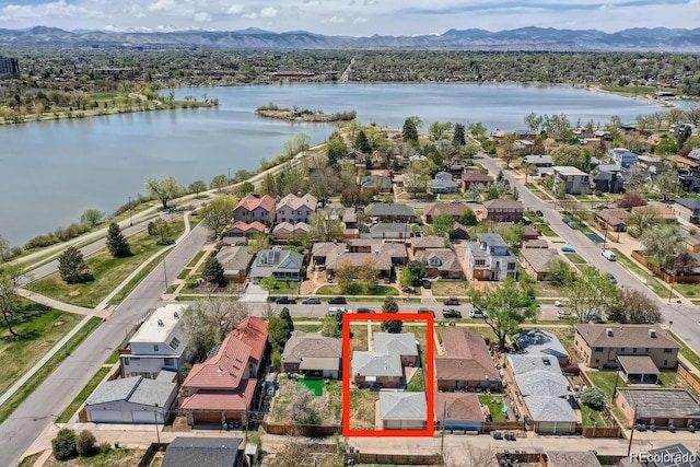 birds eye view of property with a water and mountain view