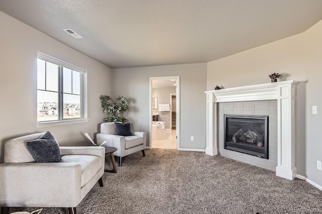 4406 Sidewinder Loop, Castle Rock, CO 80108 - sitting room featuring carpet, a tile fireplace, baseboards, and a textured ceiling