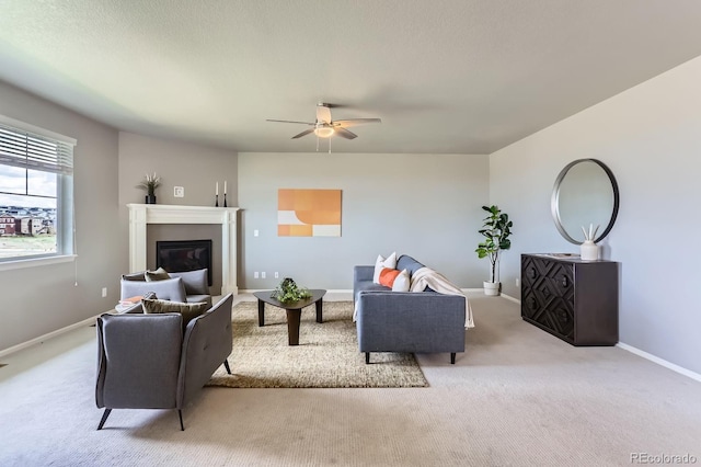 4406 Sidewinder Loop, Castle Rock, CO 80108 - living room with light carpet, ceiling fan, baseboards, and a glass covered fireplace