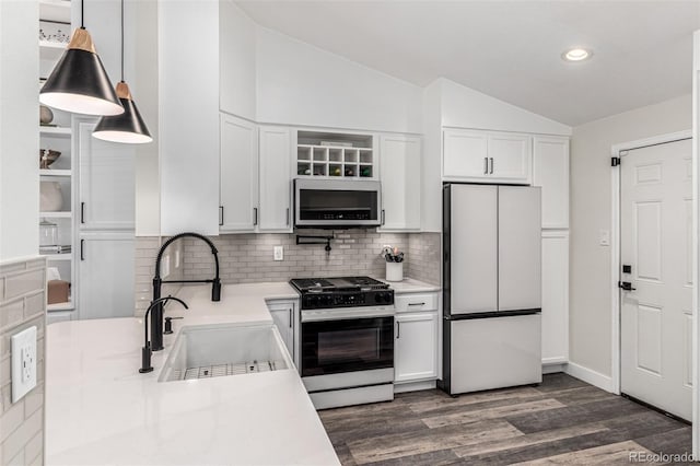 12908 Hudson St, Thornton, CO 80241 - kitchen with freestanding refrigerator, stainless steel gas range, vaulted ceiling, white cabinets, and light countertops