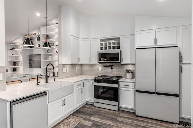 12908 Hudson St, Thornton, CO 80241 - kitchen featuring appliances with stainless steel finishes, lofted ceiling, white cabinets, tasteful backsplash, and light countertops