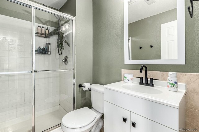 12908 Hudson St, Thornton, CO 80241 - full bath featuring a stall shower, vanity, and a textured wall