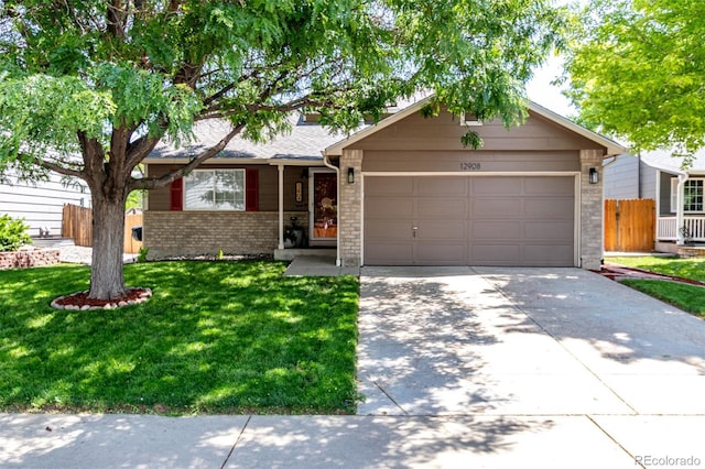 12908 Hudson St, Thornton, CO 80241 - view of front of house with an attached garage, brick siding, and driveway