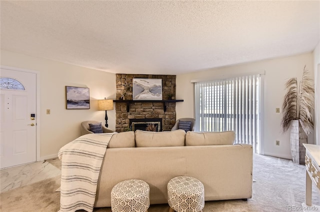 living room with light colored carpet, a fireplace, and a textured ceiling