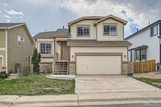 20112 E Grand Pl, Aurora, CO 80015 - view of front of property with concrete driveway, brick siding, an attached garage, and fence