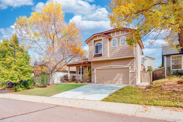 view of property with a garage and a front lawn