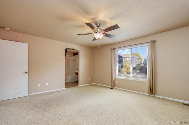 carpeted spare room with a textured ceiling and ceiling fan