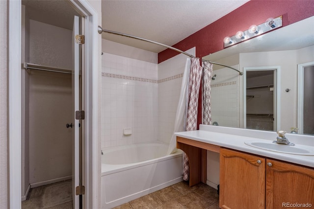 bathroom with vanity, a textured ceiling, and shower / bathtub combination with curtain