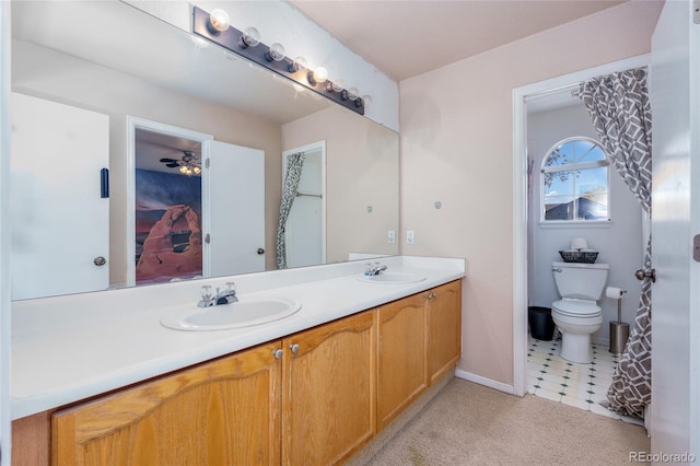 bathroom featuring ceiling fan, vanity, and toilet