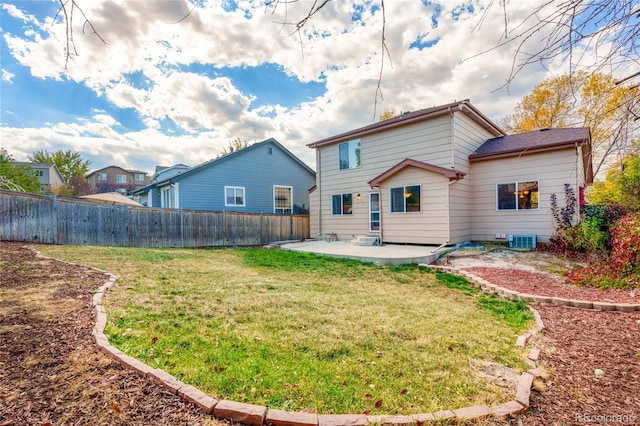 back of house with central AC, a yard, and a patio area