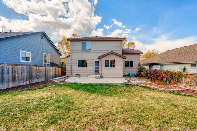 back of property featuring a lawn, a patio area, and central air condition unit