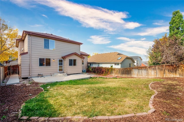 rear view of house with a yard and a patio